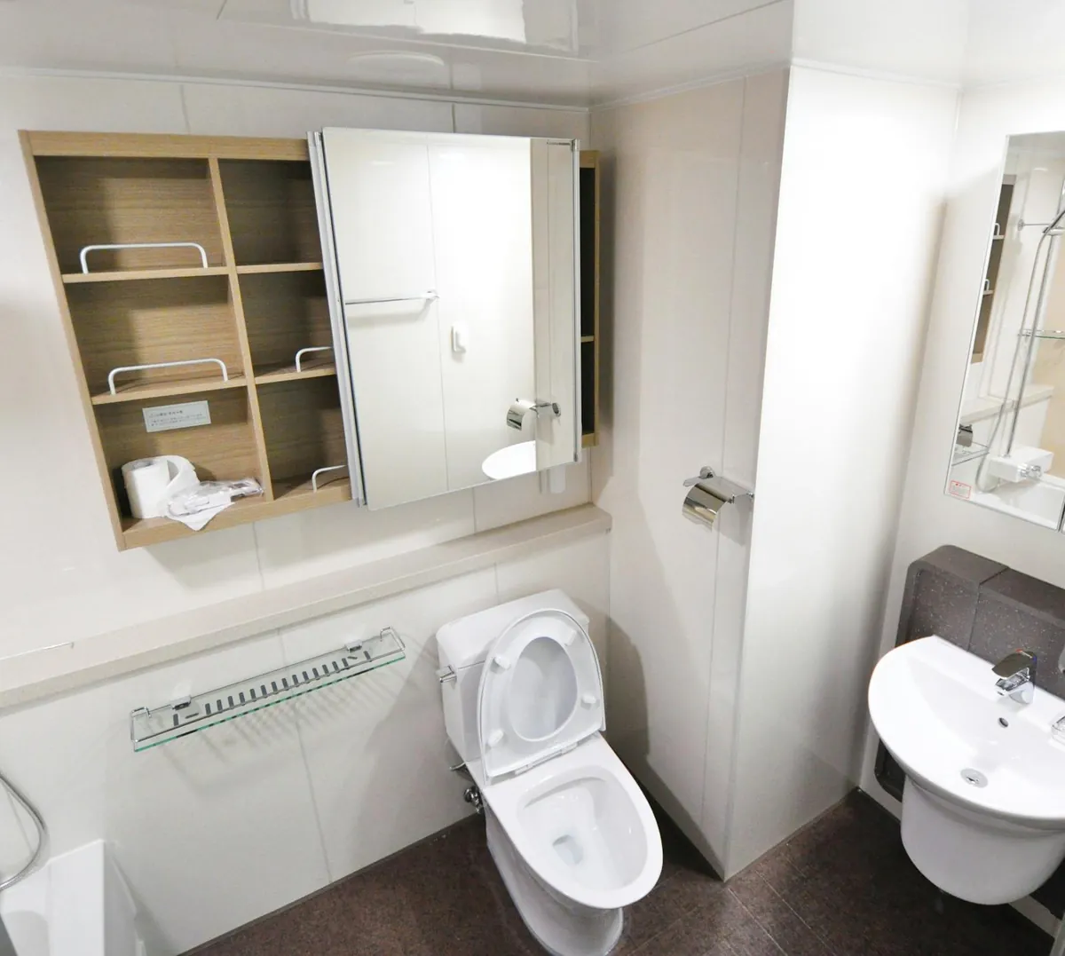 small bathroom storage organized over toilet shelves