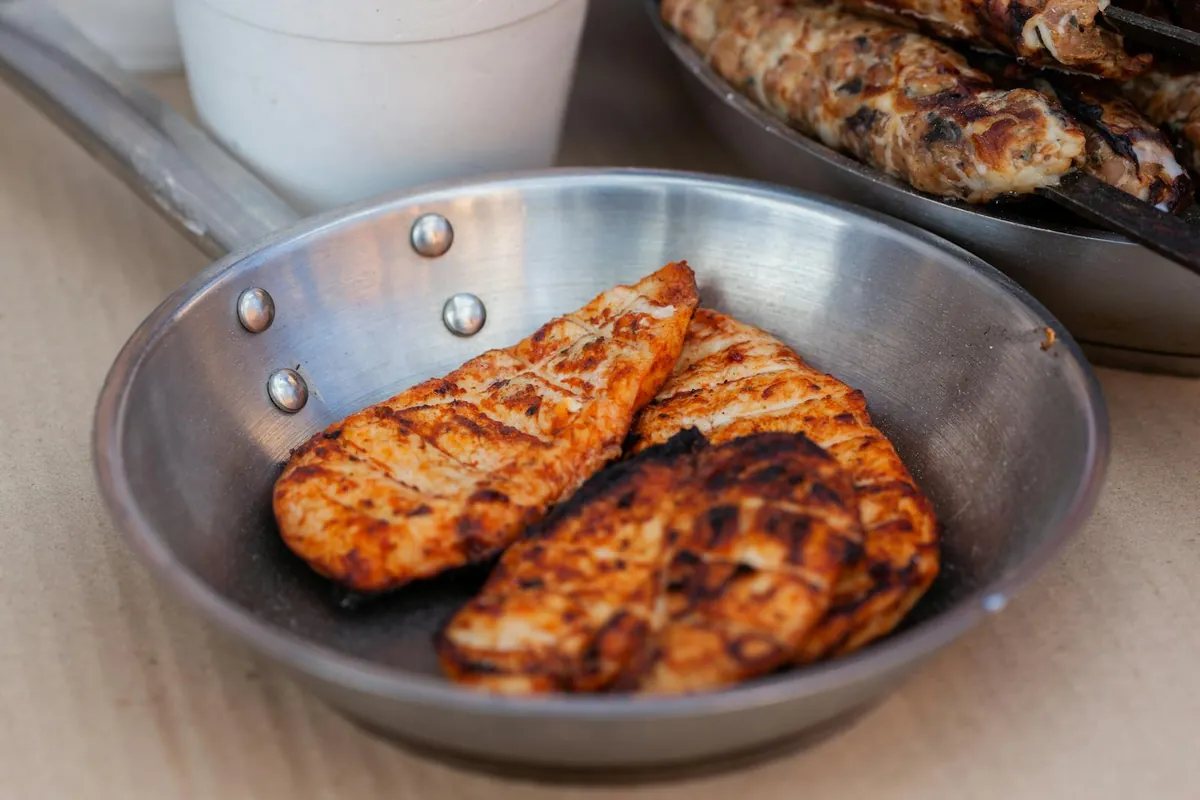 stainless steel pan searing chicken golden crust