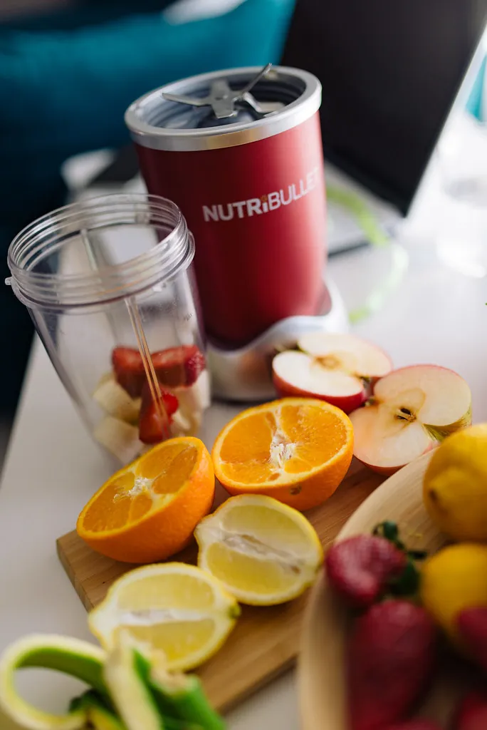 blender on counter with fruits